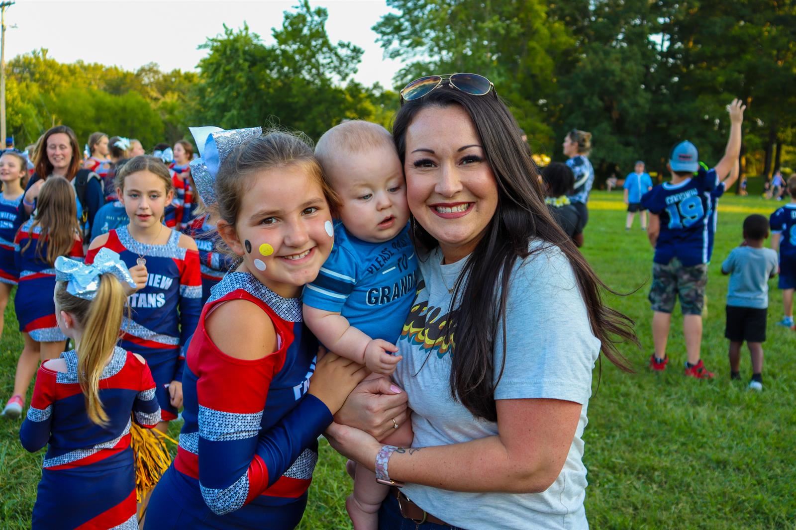 principal, baby and girl smiling
